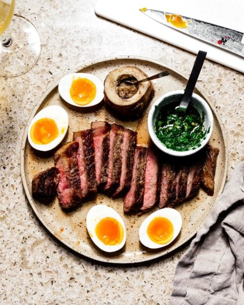 Oven roasted steak with Japanese chimichurri, roasted bone marrow, and jammy eggs