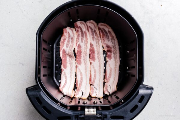 bacon in an air fryer basket | www.iamafoodblog.com