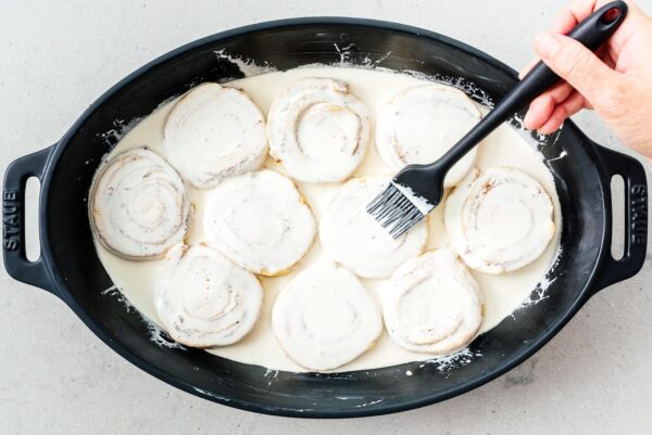adding cream to tiktok cinnamon rolls | www.iamafoodblog.com