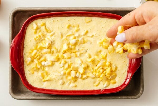 adding corn to corn pudding batter | www.iamafoodblog.com
